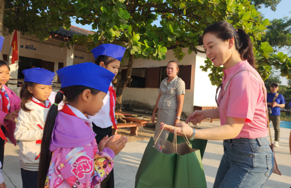  깽빠냥 초등학교를 찾은 김정화 삼성어린이집 원장이 아이들에게 학용품 선물을 나눠주고 있다. 